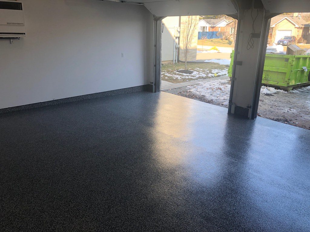 Dark flake coated garage floor with open door